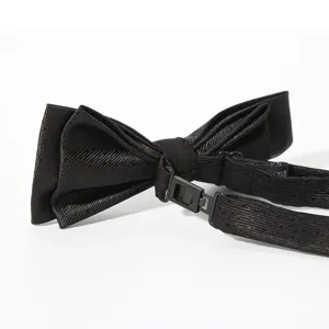 Men's black bow tie detail shot, classic polyester silk fabric with adjustable buckle strap.