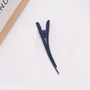 Large matte blue duckbill hair clip detail showing the fine texture and secure grip.