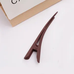 Detail view of large brown matte duckbill hair clip, elegant hair accessory for daily styling.