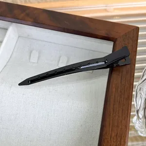 Black metal hair duckbill clip detail closeup professional styling tool hair accessory