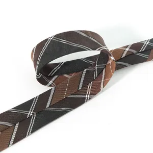 Brown plaid fabric strap detail shot showcasing classic pattern and fine woven texture.