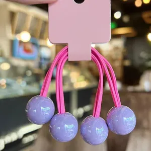 Cute candy color hair ties with glossy purple balls on pink display card for girls sweet styling.