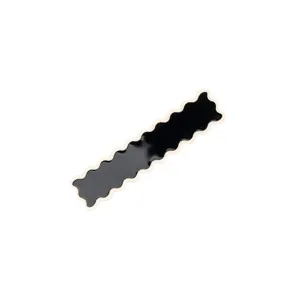 Detailed close-up of a chic black wavy hair clip with white trim, stylish daily hair accessory.