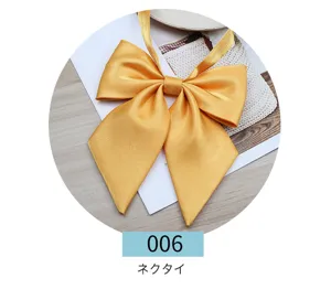 Gold silk bow tie detail, Japanese JK uniform collar accessory, smooth fabric finish close up.