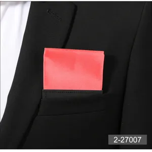 Detailed close-up of a vibrant red men pocket square with black holder inside a formal suit breast pocket.