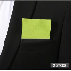 Bright green pocket square detail in a black suit pocket, ideal for formal business wear.