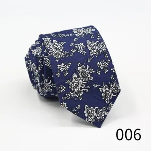 Navy blue floral men's tie, casual cotton slim necktie rolled neatly on white background