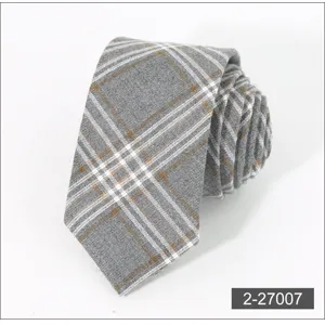 Grey plaid tie close-up detail, featuring clear fabric texture and neat woven pattern.