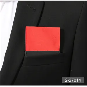 Detail shot of a red pocket square inserted in a black suit pocket, ideal for formal wear.