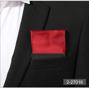 Close-up detail of a vibrant red satin pocket square neatly tucked inside a black suit pocket.