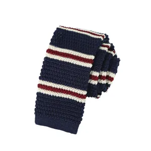 Detailed shot of a classic navy blue, white, and red striped knitted tie, textured fabric.