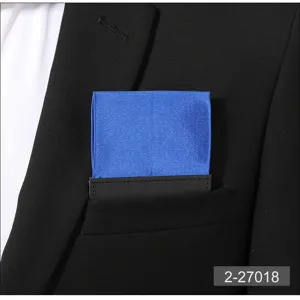 Detailed close-up of a vibrant blue silk pocket square tucked neatly in a black suit pocket.