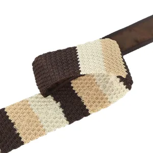 Detailed close-up view of a stylish brown and beige striped knitted tie accessory.