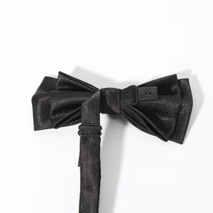 Black textured men's bow tie detail showing adjustable strap and secure buckle closure.