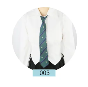 Detail view of the green and blue striped JK uniform tie featuring a small crest embroidery.