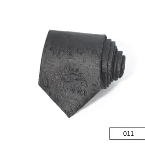 Close-up detail of dark grey business necktie featuring vintage paisley pattern and texture.