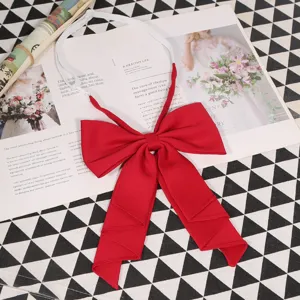 Detail shot of a solid red big bow JK uniform tie with elastic neck strap for cute style.