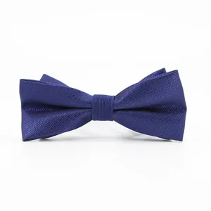 Close up detail of a classic dark blue textured bow tie for men, perfect for formal suits.