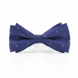 Close-up of a dark blue bow tie with subtle silver pattern, textured fabric detail.