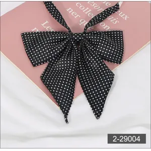 JK uniform black and white polka dot pointed collar bow tie detail shot, sweet style accessory.