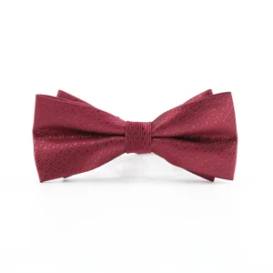 Burgundy textured bow tie detail, elegant fabric close up shot for men's formal suit wear.
