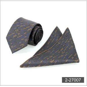 Close-up detail of mens business tie and pocket square set featuring abstract dash pattern.