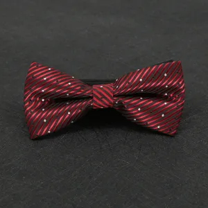Detailed view of a classic red and black striped bow tie with white dots for men's formal suit.