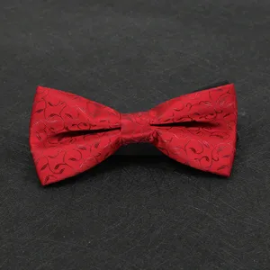 Detailed view of a classic red patterned bow tie, featuring fine textured fabric for formal wear.