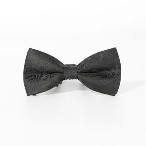 Close-up detail of a black classic men's bow tie featuring intricate woven paisley patterns.