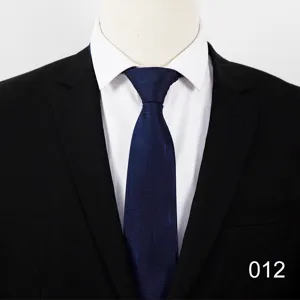 Close-up detail of dark blue men business formal tie with subtle abstract texture pattern.