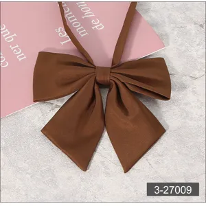 Vue rapprochée détaillée d'un nœud papillon marron uni pour uniforme JK avec de jolies pointes.
