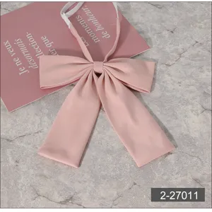 Pink JK bow tie with adjustable strap, sweet Japanese style school uniform accessory detail.