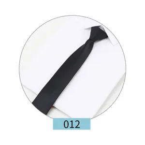 Detail view of a classic black business necktie for men, shown on a crisp white shirt.