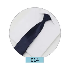 Close-up detail of a dark blue formal men's necktie displayed on a crisp white dress shirt.