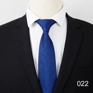 Close-up detail of a classic blue men's necktie featuring a stylish geometric square pattern.