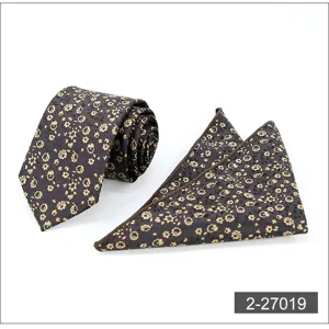 Detailed close-up of men's elegant brown floral tie and matching pocket square set.