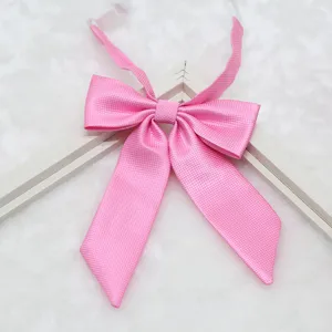 Pink fine-ribbed bow tie detail showing the textured fabric and sharp corner collar design for uniform.