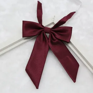 Detailed view of burgundy JK uniform bow tie, fine ribbed fabric with pointed long handle design.