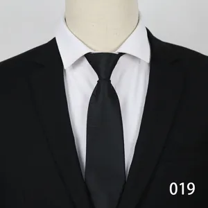 Men's formal business black tie paired with suit jacket and white dress shirt detail.
