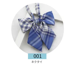 Detail shot of a blue plaid JK uniform bow tie, showing the fabric texture and sharp corner.