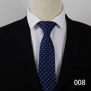 Detailed view of a classic blue dot men business tie worn with a white shirt and black suit.