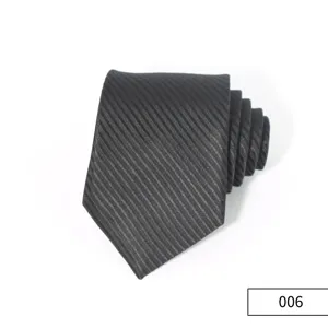 Detailed view of a rolled black business men tie with subtle diagonal stripes texture.