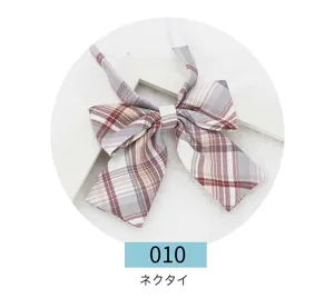 Detailed view of Japanese school style plaid bow tie, classic stripe fabric accessory close up.