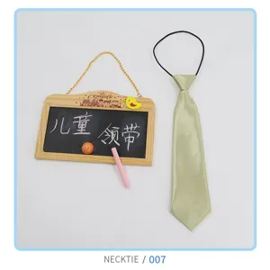 Close-up detail of the light green children tie featuring elastic band and smooth satin fabric.