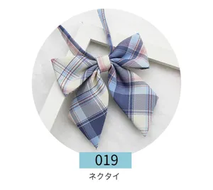 Detailed close-up of Japanese JK uniform plaid bowtie, pointed sailor collar bow.