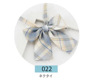 Detailed view of Japanese JK uniform plaid bow tie in blue and yellow striped design.