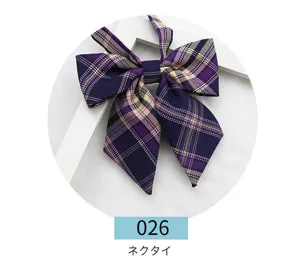 Detailed view of a preppy style dark purple plaid JK uniform bow tie, sharp corner design.