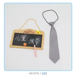 Detailed view of grey kids necktie with elastic band, soft fabric close-up display
