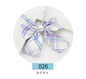 Detail view of Japanese JK plaid bow tie, purple and yellow striped ribbon accessory