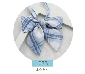 Close-up detail of a blue plaid JK uniform bow tie, featuring a stylish pointed double-layer design.